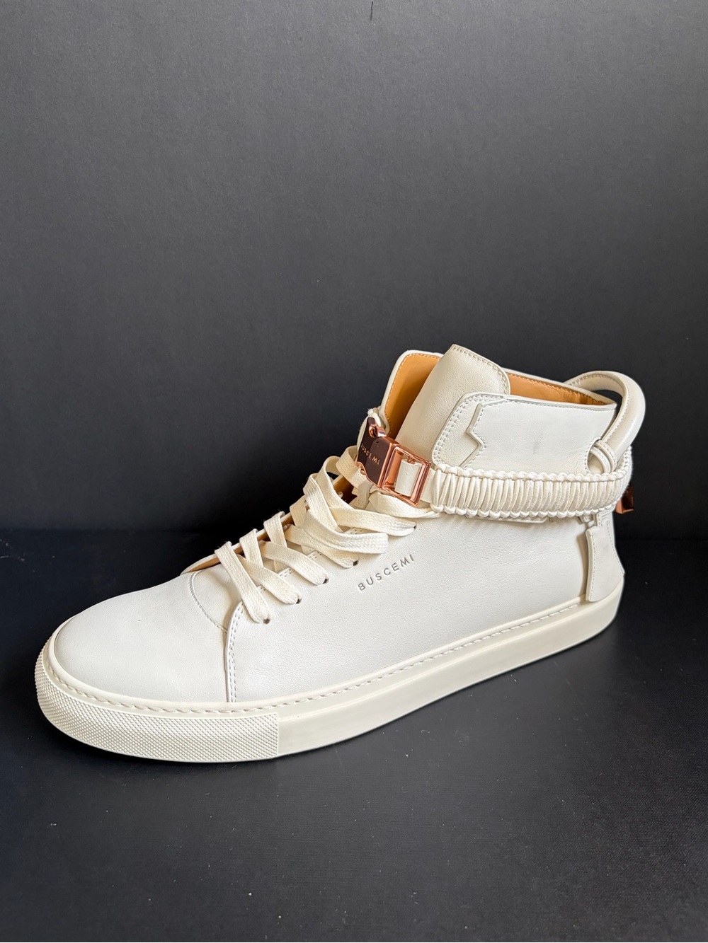 Buscemi high-top sneakers featuring metallic rose gold hardware and a signature